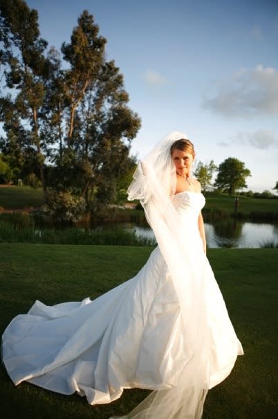 Victoria in her wedding dress beside a lake